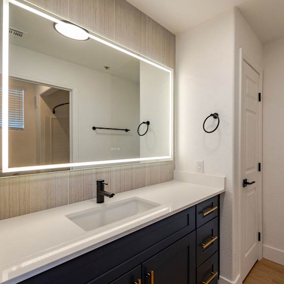A bathroom with a sink and mirror.