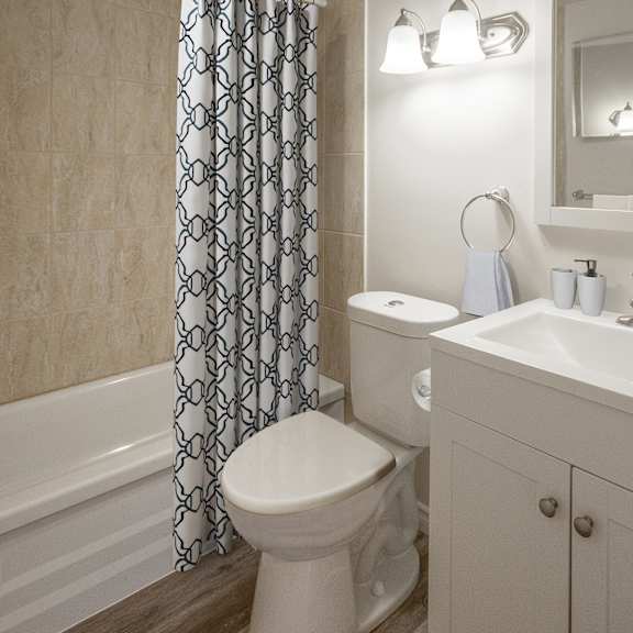 A white toilet sits next to a white sink in a bathroom.
