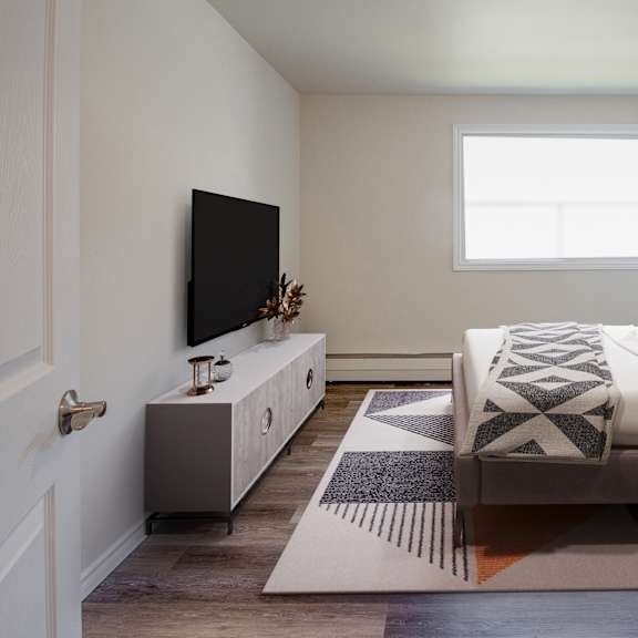 A bedroom with a large bed and a painting on the wall.