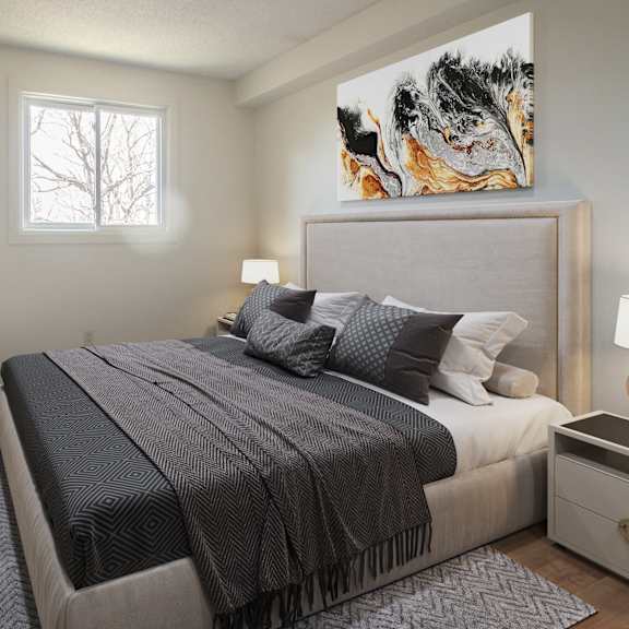A bedroom with a large bed and a painting on the wall.