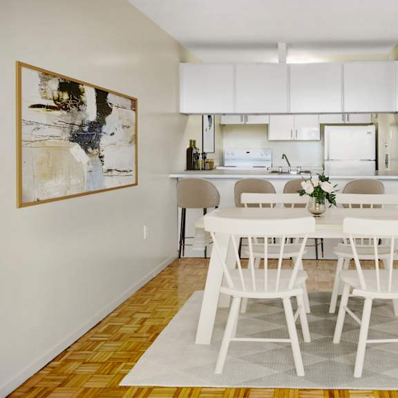 A living room with a grey couch, a round table, and a television.