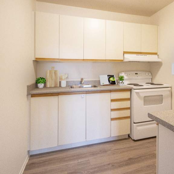 A kitchen with a white oven and a white fridge.