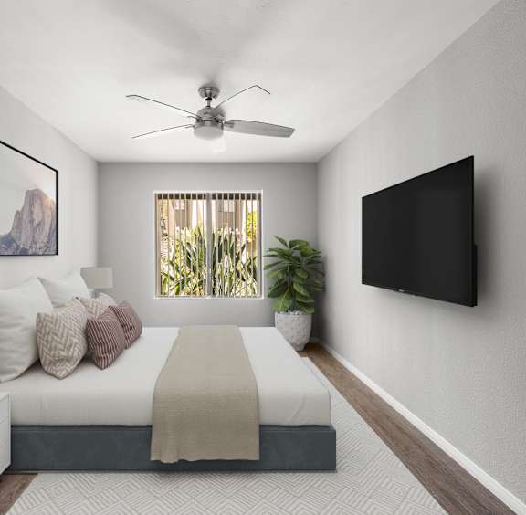 A living room with a white couch, a fireplace, and a painting on the wall.