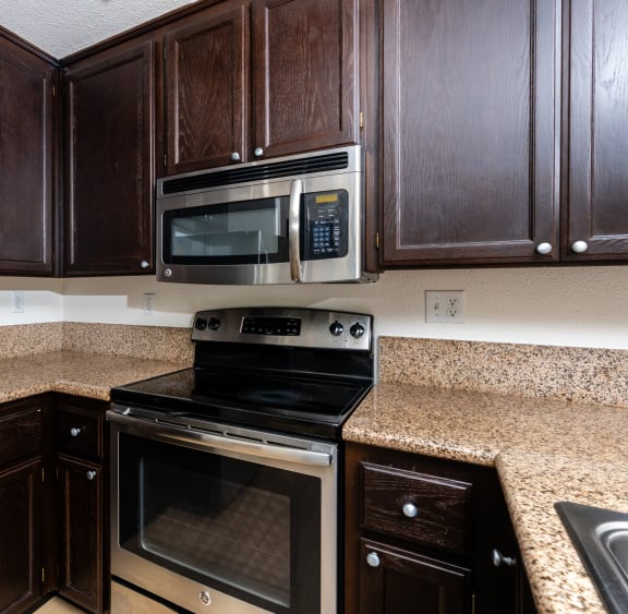 a kitchen with a stove microwave and cabinets