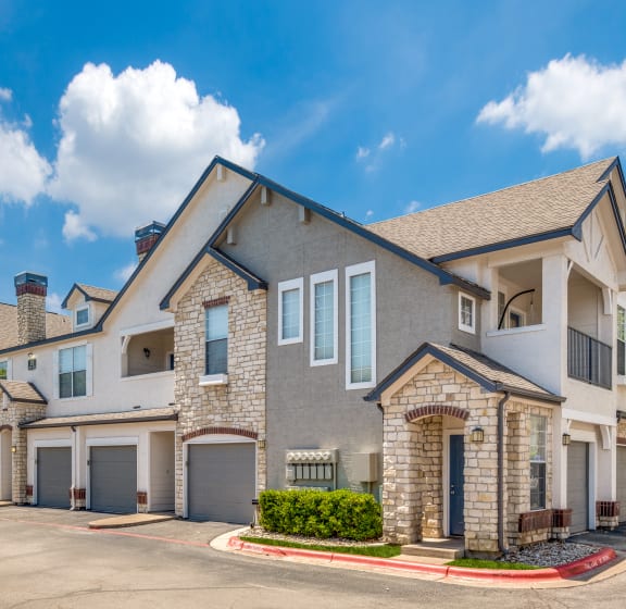 external view of a house with a driveway and garage doors