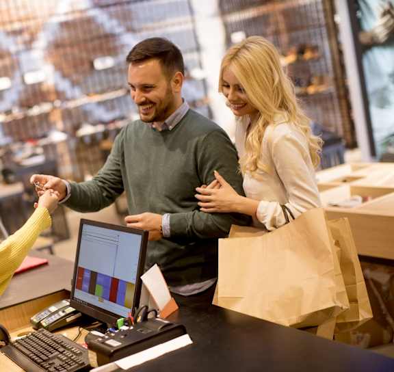 a person handing a paper bag to another person