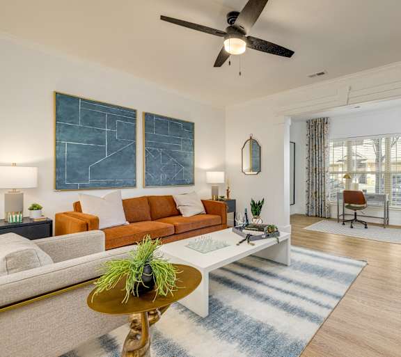 A living room with a brown sofa and a coffee table.