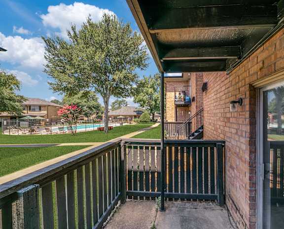 the view from the balcony of a house with a pool