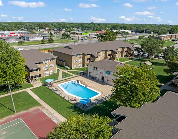 an aerial view of a swimming pool in the middle of an apartment complex