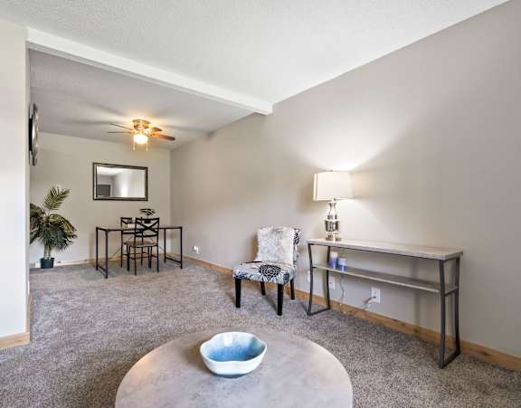 a living room with a couch and a chair and a table
