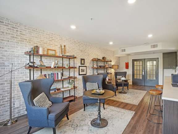A living room with a brick wall and a television.