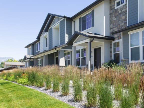 Parc on Center Townhomes Exterior View with Green Lawn and Plants