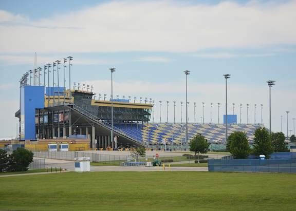 A large stadium with a red sign on the top.