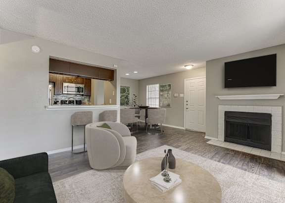 a living room with a couch and chairs and a fireplace at The Manhattan Apartments, Dallas, TX, 75252