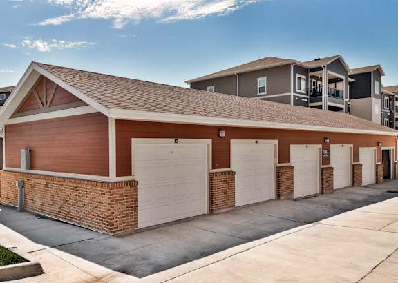 A row of garage doors in front of a building.