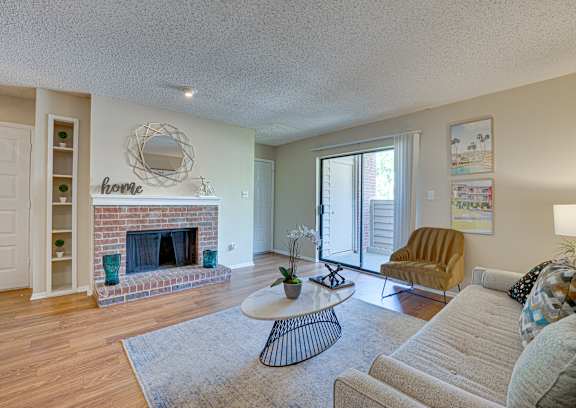 A living room with a fireplace and a couch.