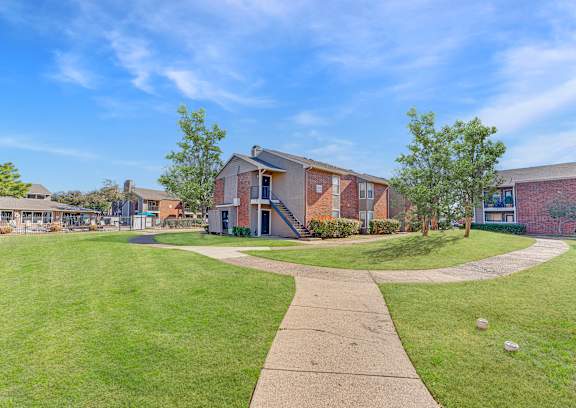 A sunny day at a residential area with houses and a clear blue sky.