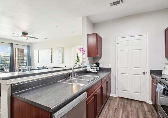 a kitchen with a stainless steel counter top and a sink