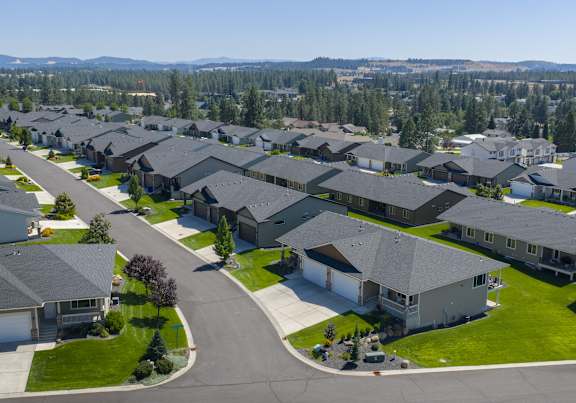 A suburban neighborhood with houses and a road.