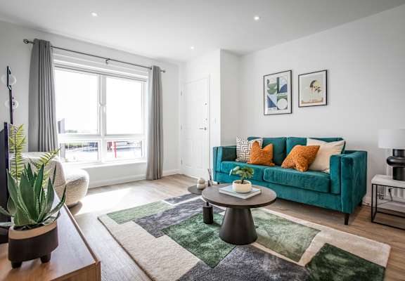a living room with a blue couch and a coffee table
