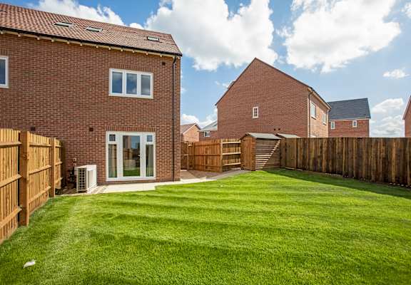 a garden with a lawn and a house