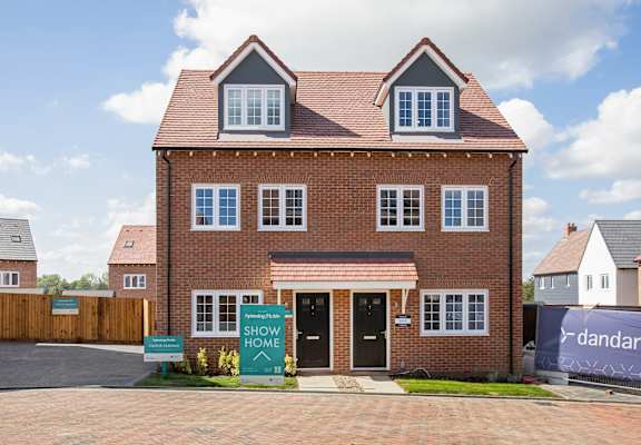 an image of a house with a show home sign in front of it