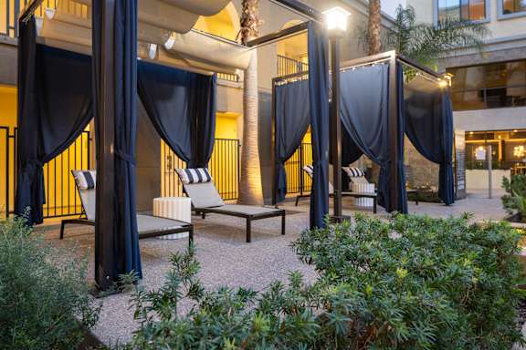 A patio area with a canopy and chairs.