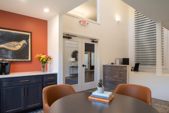 a dining area with a table and chairs