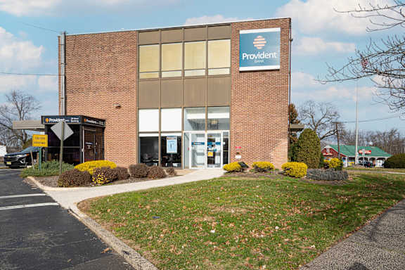 the front of a office building with a sign on it