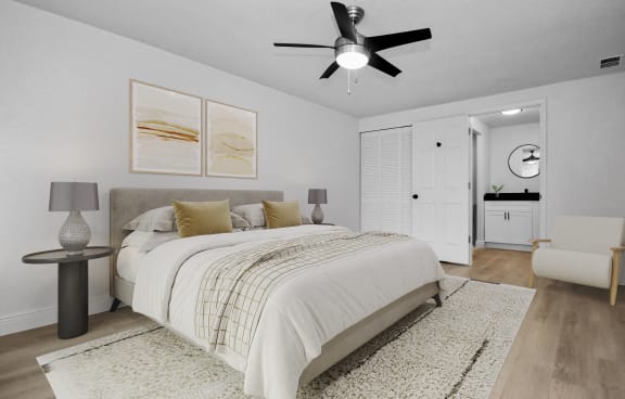 a bedroom with a large bed and a ceiling fan
