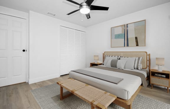 a bedroom with a bed and a ceiling fan