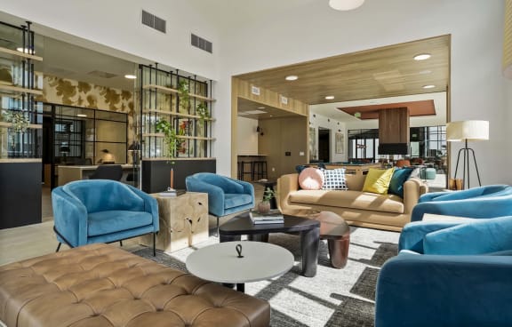 a living room with blue chairs and couches