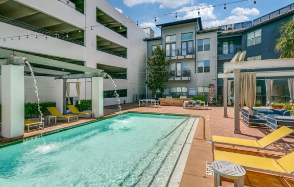 a swimming pool with buildings in the background