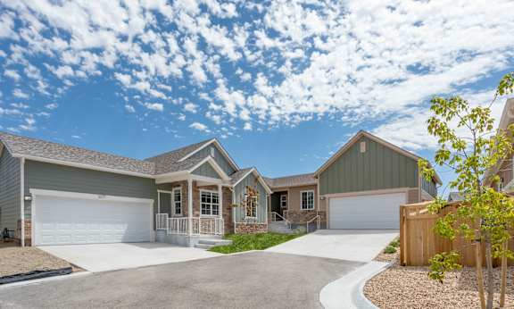 a house with two garage doors and a driveway