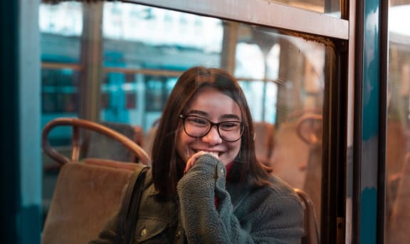 a woman sitting on a train looking out the window
