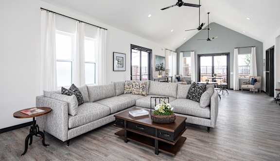 a living room filled with furniture and a large window