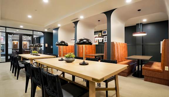 A restaurant with wooden tables and chairs.
