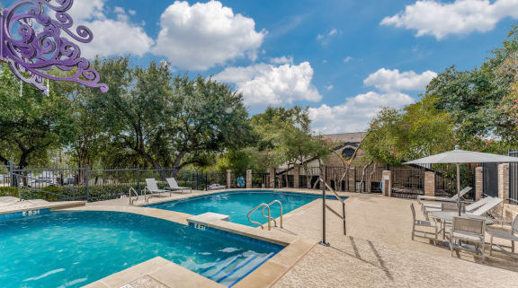 a swimming pool with chairs and a resort style pool