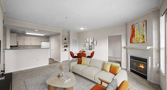 a living room with a kitchen in the background at The Claremont Apartment Homes, Overland Park Kansas