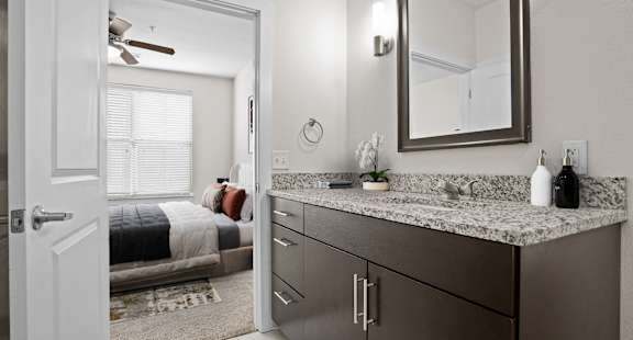 A bathroom with a vanity and a mirror.