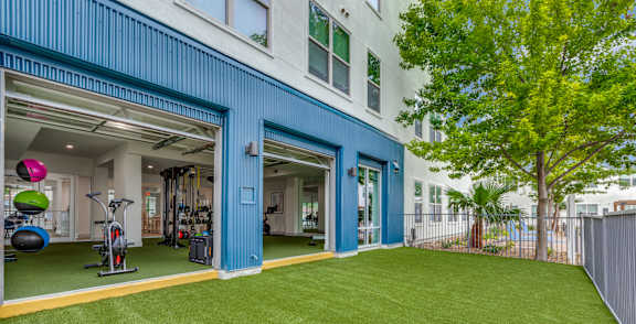 A gym with a green floor and a blue wall.