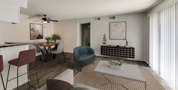 an open living room and dining room with a table and chairs and a ceiling fan