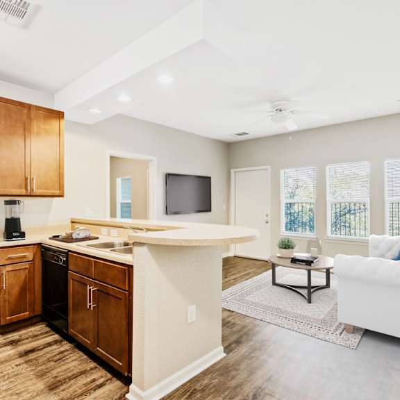 A kitchen with wooden cabinets and a black oven.