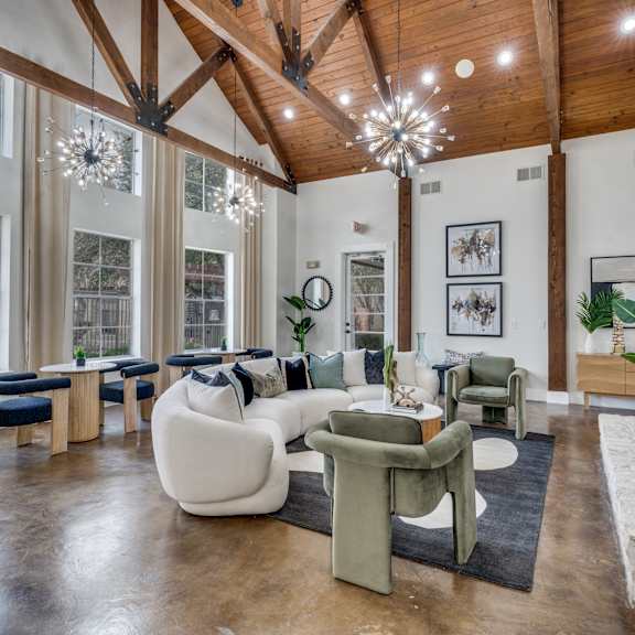 A living room with a white couch and a wooden ceiling.