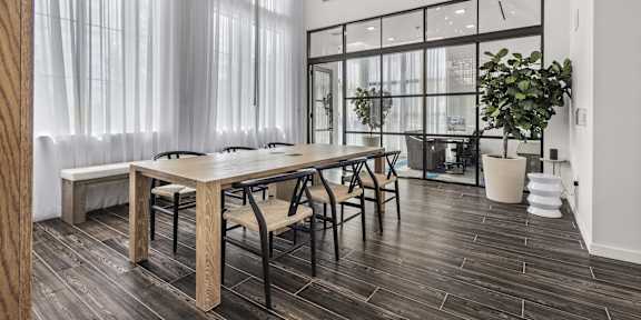 A dining room with a wooden table and chairs.