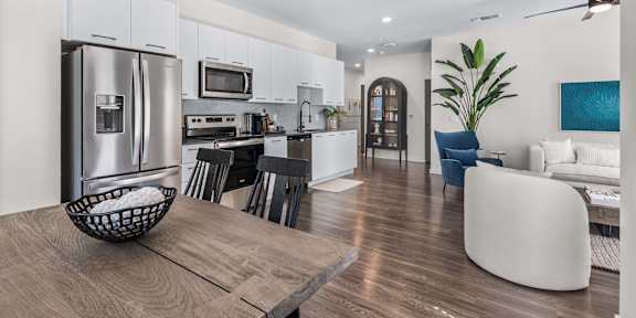A modern kitchen with a dining area and a living room.