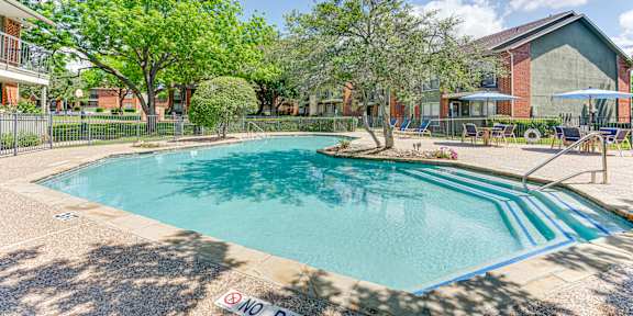A living room with a fireplace and a television. at Bardin Oaks Apartments, Arlington