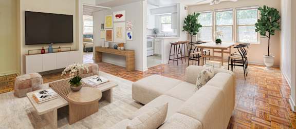 A living room with a couch, a coffee table, and a television. at Park Georgetown Apartments, Arlington, VA, 22209