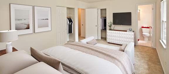A bedroom with two beds and a television. at Fairfax Square Apartments, Fairfax, VA, 22031