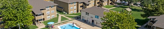 an aerial view of a swimming pool in the middle of an apartment complex